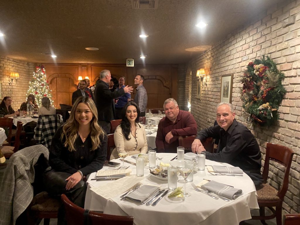 Four members of the PC Professional team sitting around a dinner table.