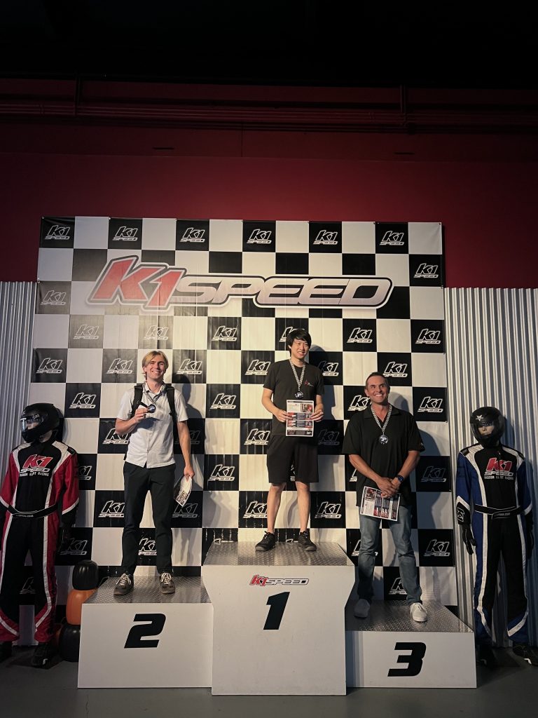 The top three professional PC racers from the first circuit, standing on the winners’ podium.
