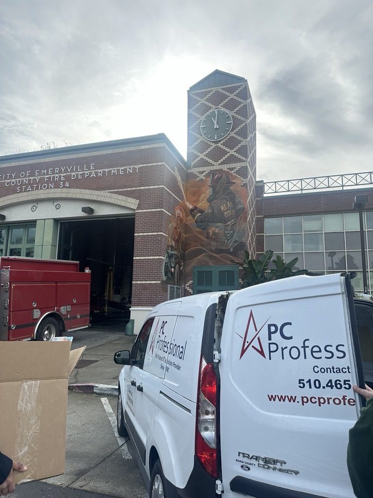 The PC Professional van in front of a fire station.