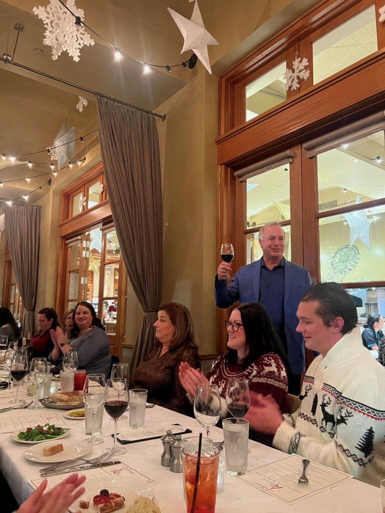 The PC Professional CEO making a toast at the holiday dinner.